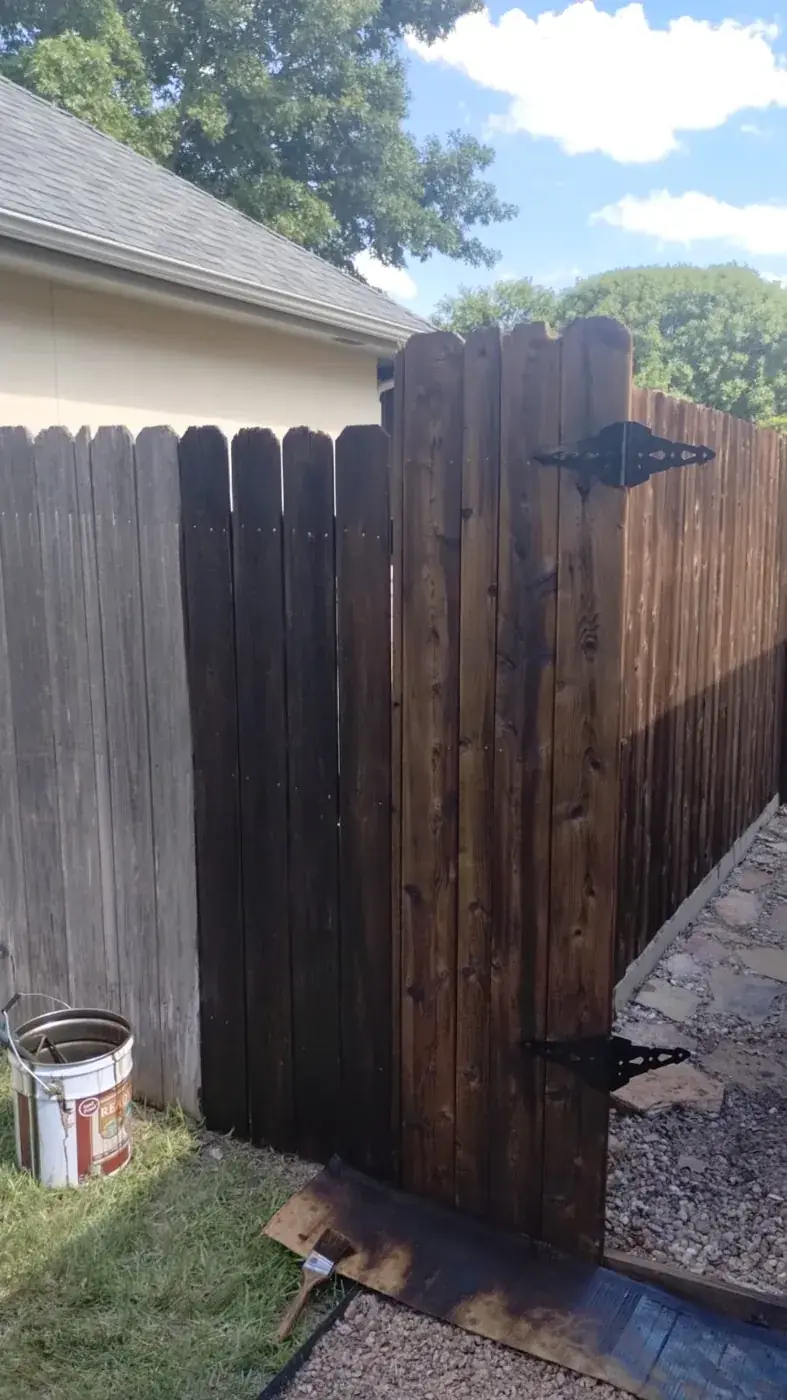 Wooden fence and gate during an Alvarez Painting staining project