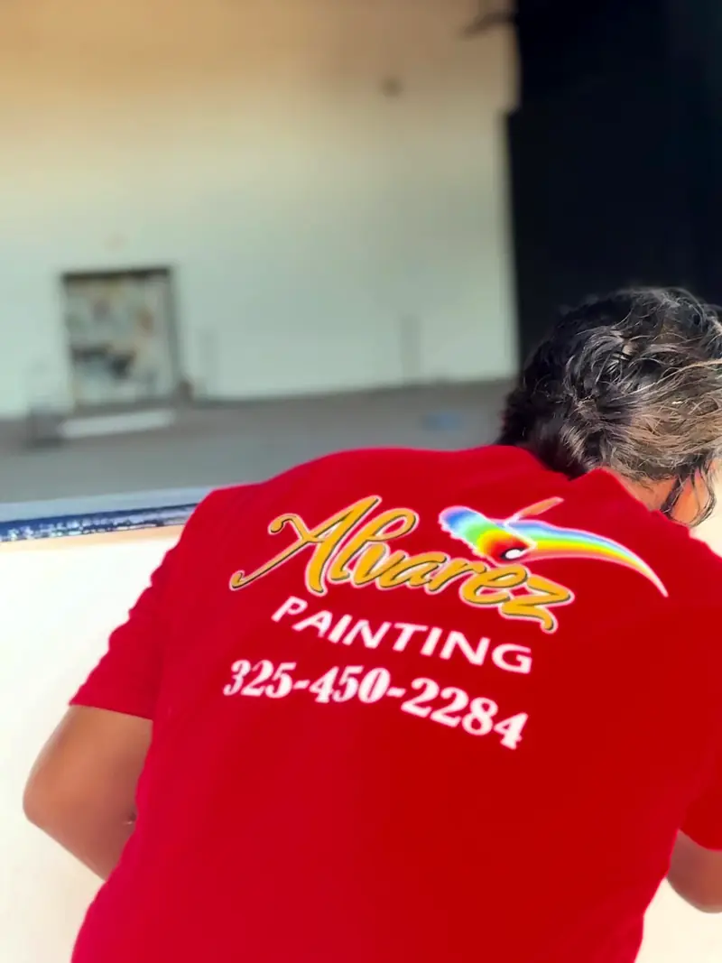 Alvarez Painting crew member in a company shirt at work indoors