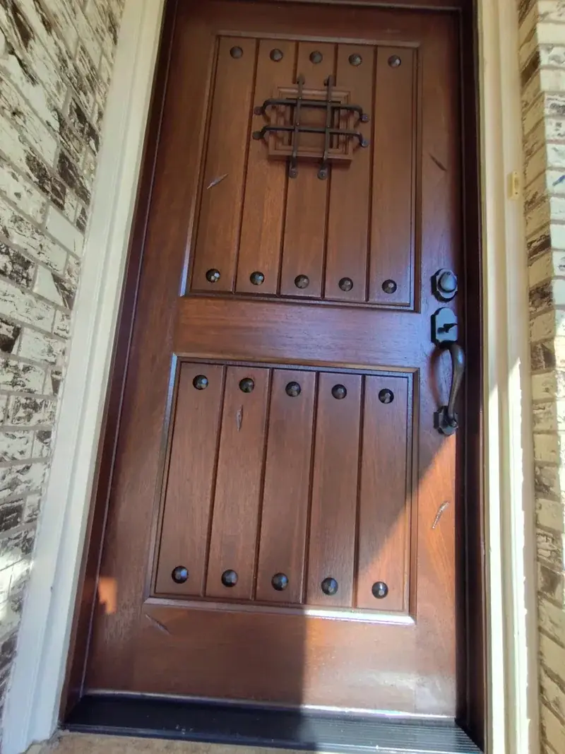 Front door freshly stained dark walnut by Alvarez Painting in San Angelo